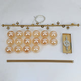 Full disassembled parts of 16-light brushed gold amber ribbed glass linear chandelier hardware
