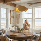 Wavy rattan pendant light in bright boho room