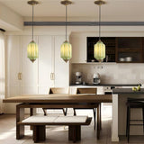 Vintage green ceramic pendant lights above a wooden dining table in a modern kitchen