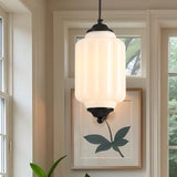 Close-up of white ribbed glass pendant light with black metal fixture