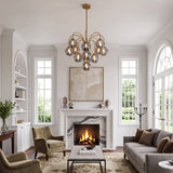 Brushed gold smoke bubble glass chandelier hanging over modern farmhouse living room fireplace