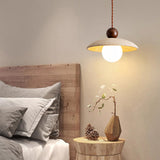 Bedroom scene of natural travertine pendant light with bulb
