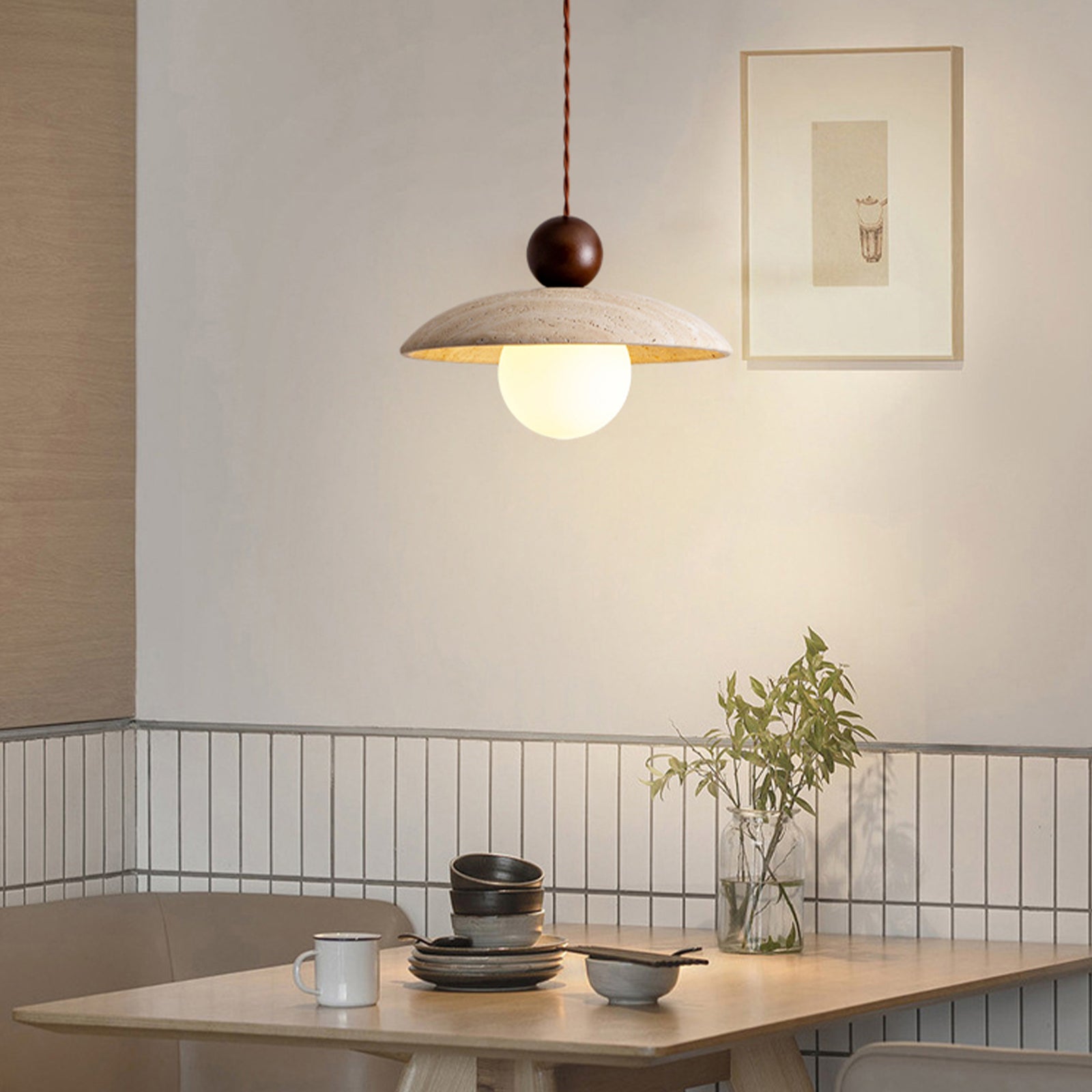 Travertine pendant light above wooden dining table
