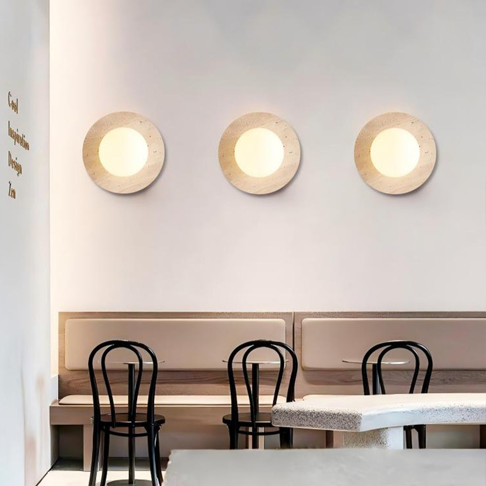 Three travertine wall sconces in a row, cafe interior lighting