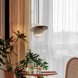 Walnut brown travertine pendant light by window