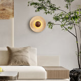 Natural travertine wall sconce with wood center in living room