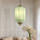 Jade green glass pendant lamp in a bright room with white shutters
