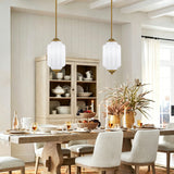 Two vintage white frosted glass pendant lights over farmhouse wooden dining table